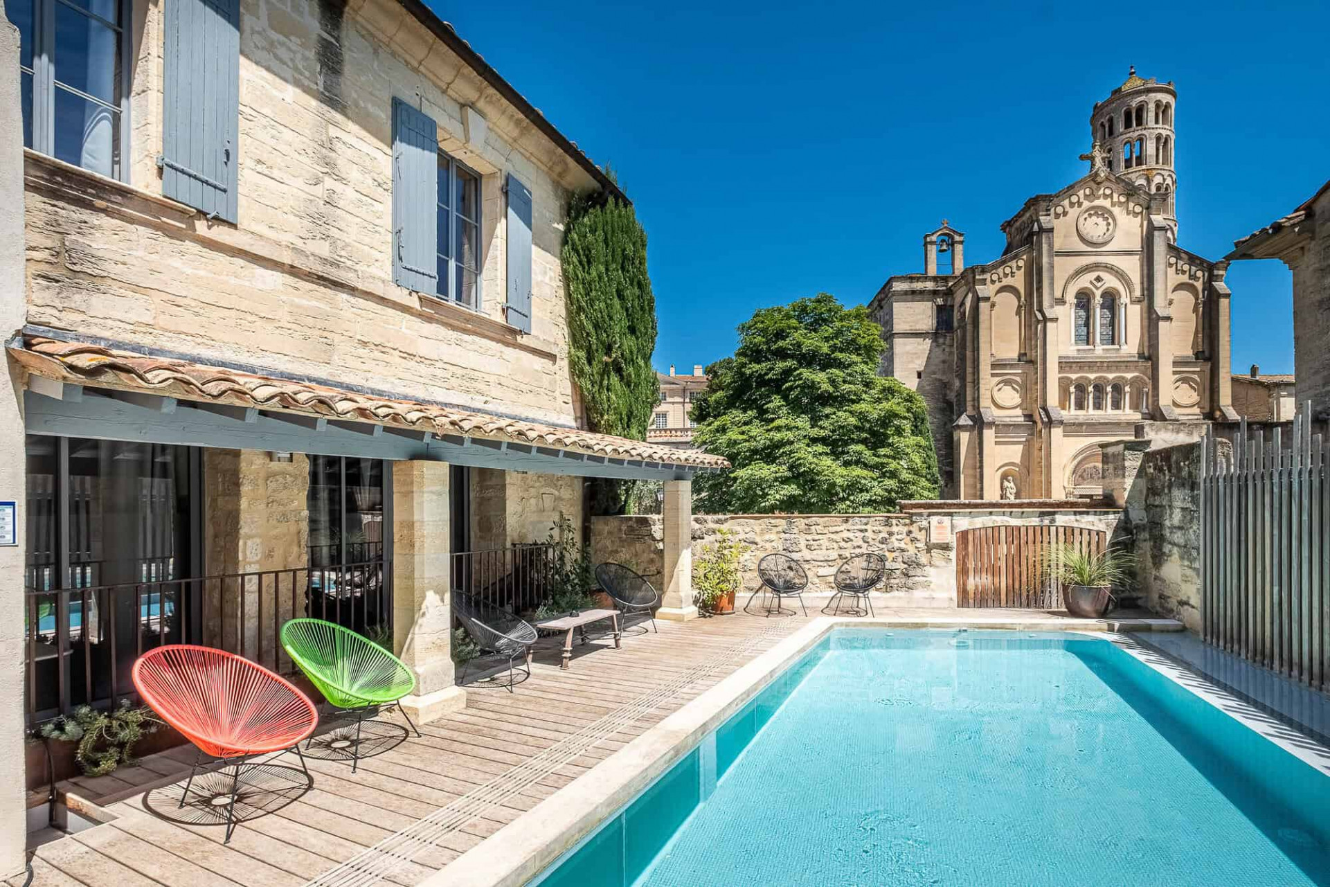 Terrace and pool with views of a tower at Boutique Hotel Entraigues in Uzès, France